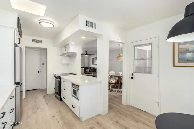 a kitchen with granite countertop a sink and a stove top oven