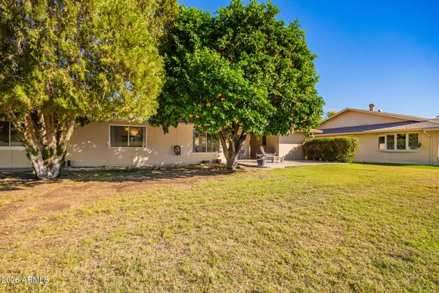 a front view of a house with a big yard