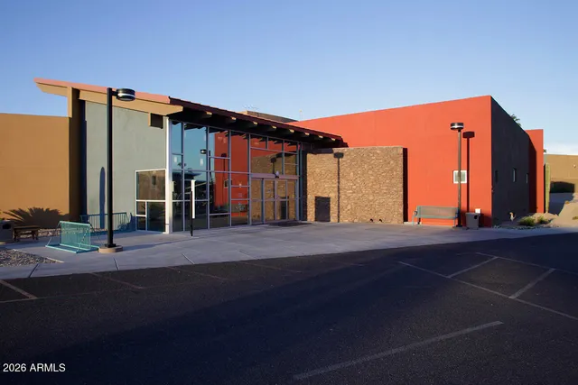 a view of a water fountain and a dining table and chairs with wooden floor