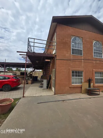 a living room with furniture and a ceiling fan
