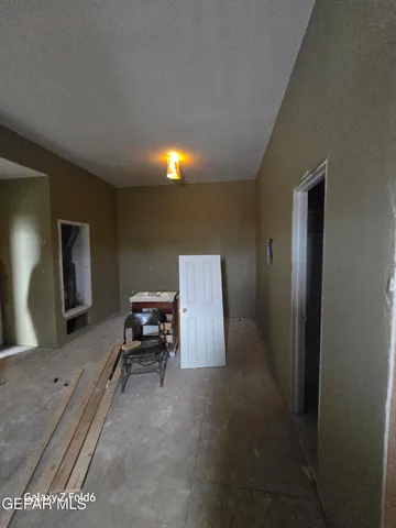 a view of a storage room with a window and fireplace