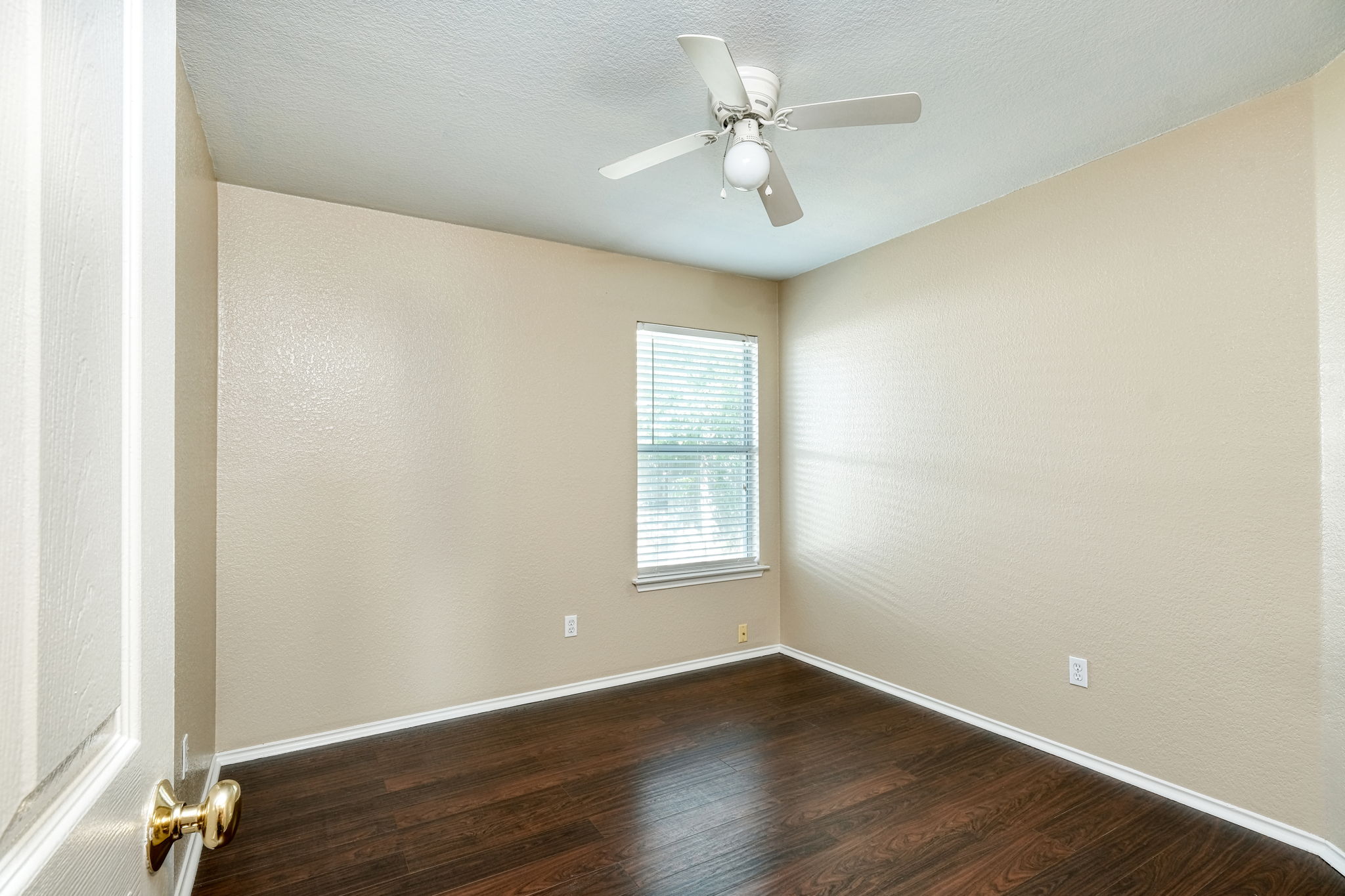 124 Hunter Rex Way Kyle, TX 78640 - Photo 9 of 14 Room featuring wood-finish flooring, neutral wall tones, and a window with blinds
