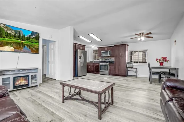 a living room with furniture and a kitchen view
