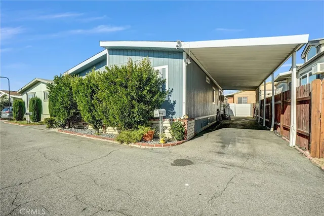a view of a house with potted plants