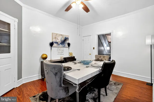 a view of a dining room with furniture and wooden floor