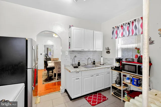 a kitchen with a refrigerator and cabinets