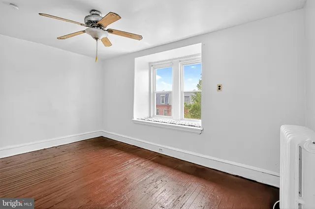 a view of a house with a yard and wooden fence