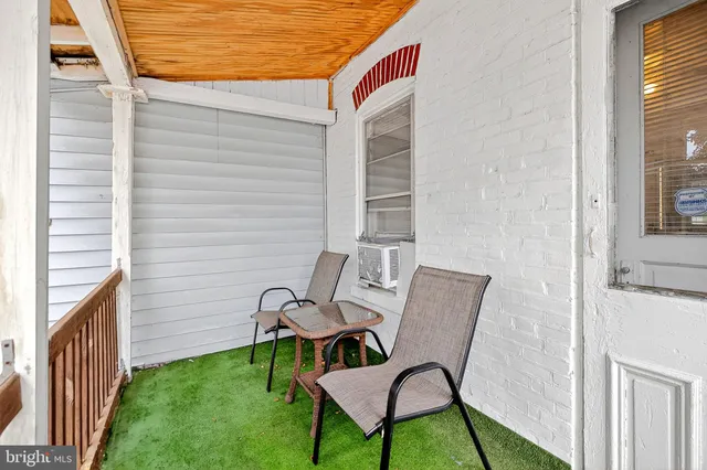 a view of a two chairs in the balcony