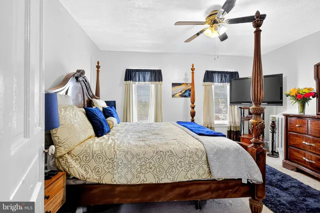 a bed room with a bed and a chandelier