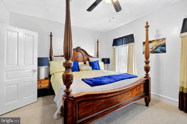 a bedroom with bed and wooden floor