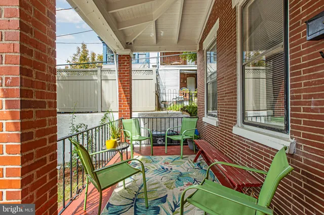 a view of a chairs and table in the balcony