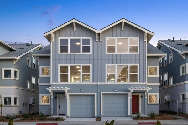 a front view of a residential apartment building with a yard
