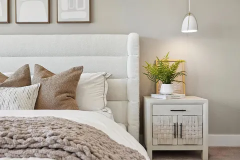 a living room with furniture a mirror and a large window