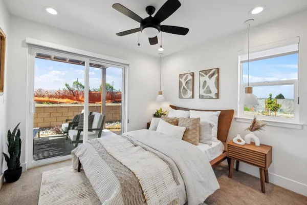 a bedroom with a bed and painting on the wall