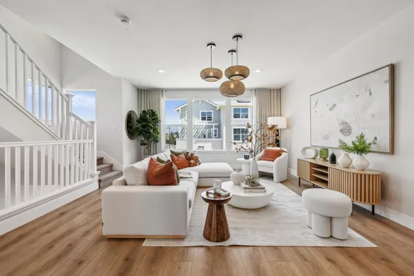 a living room with fireplace furniture and a wooden floor