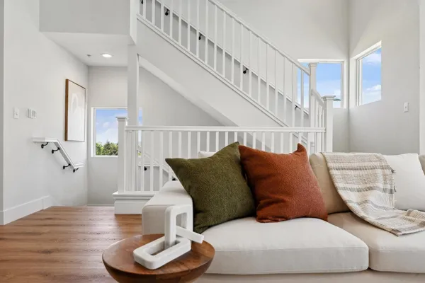 a living room with furniture and a wooden floor