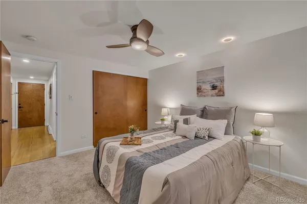 a bedroom with bed and a chandelier