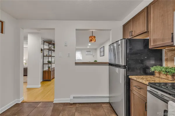 a kitchen with stainless steel appliances granite countertop a refrigerator and a stove