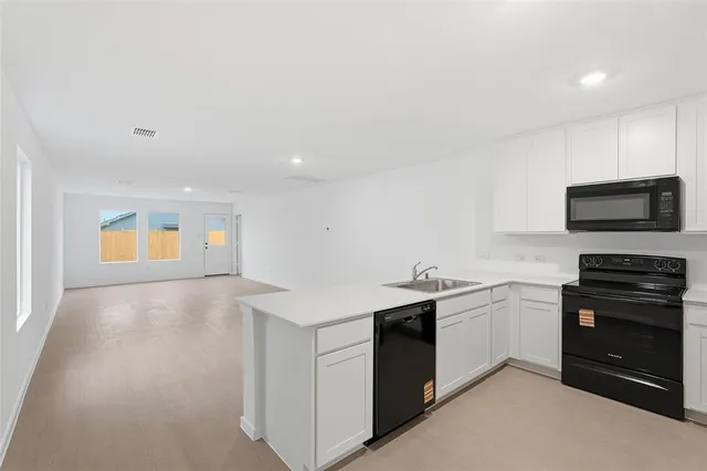 a kitchen with stainless steel appliances granite countertop a sink and stove top oven