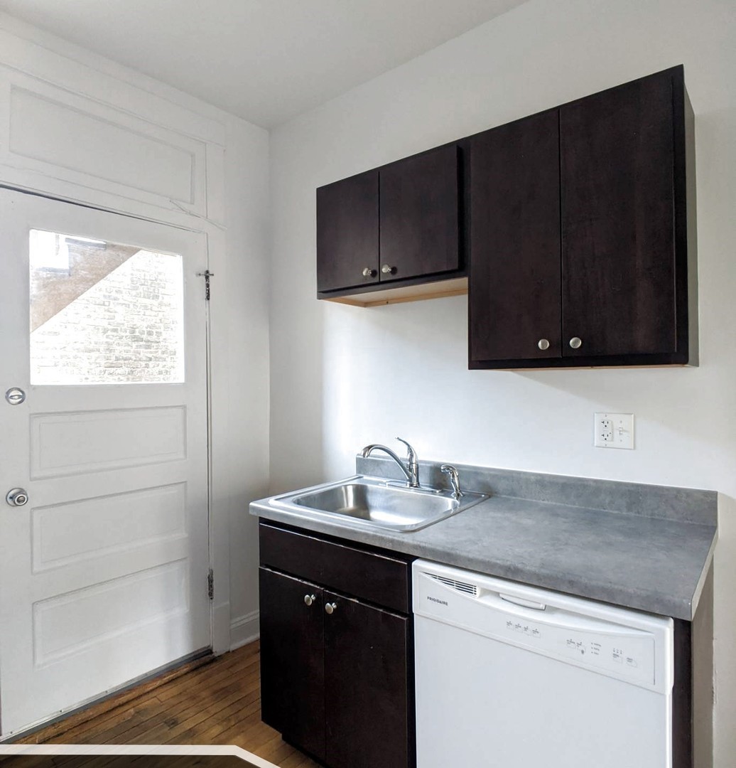 2919 West George Street, Unit 2 Chicago, IL 60618 - Photo 6 of 14 a kitchen with a sink and a microwave oven