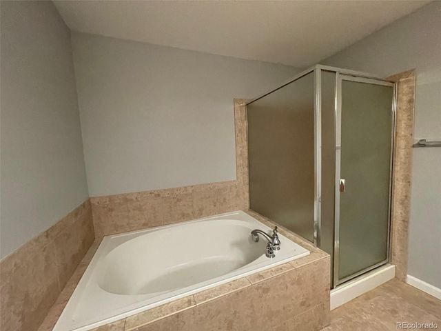 a bathroom with a tub and shower