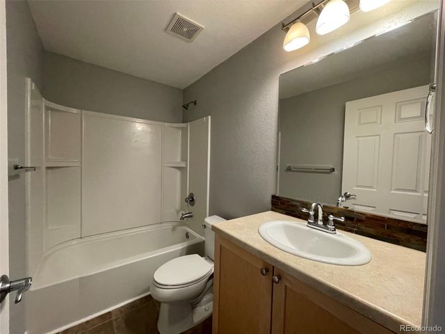 a bathroom with a sink toilet mirror and shower
