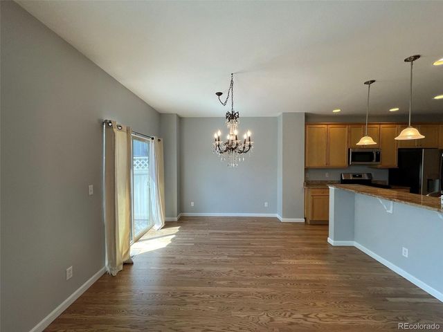a view of a kitchen with a sink and dishwasher wooden floor
