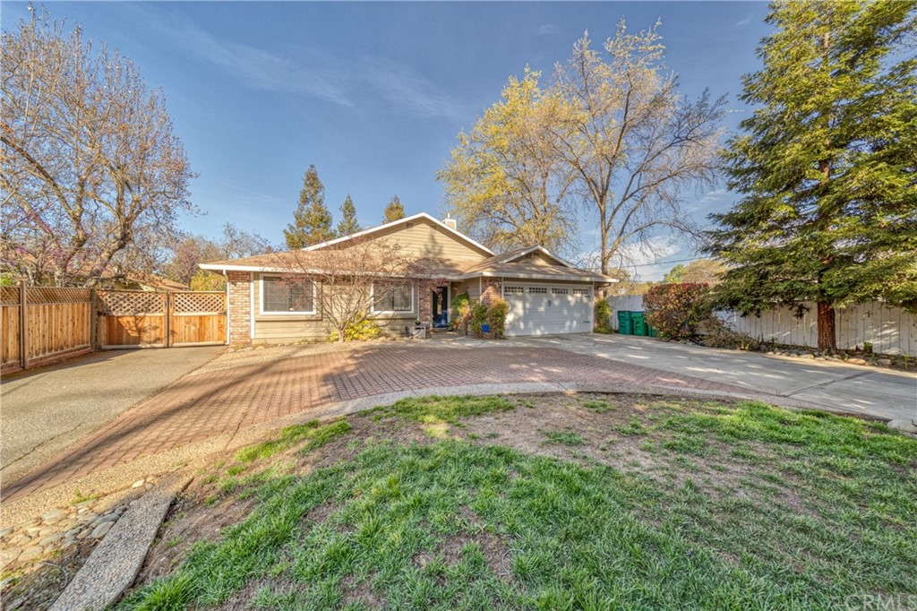 704 Miller Avenue Chico, CA 95928 - Photo 1 of 38 a front view of a house with a yard and large trees