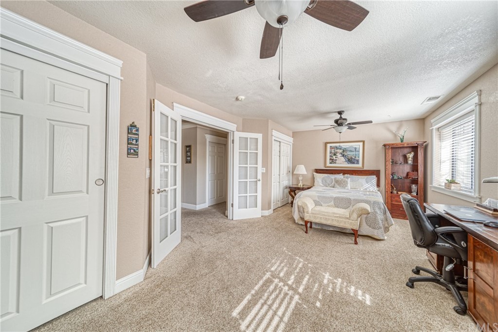 704 Miller Avenue Chico, CA 95928 - Photo 13 of 38 a spacious bedroom with a bed and a chandelier