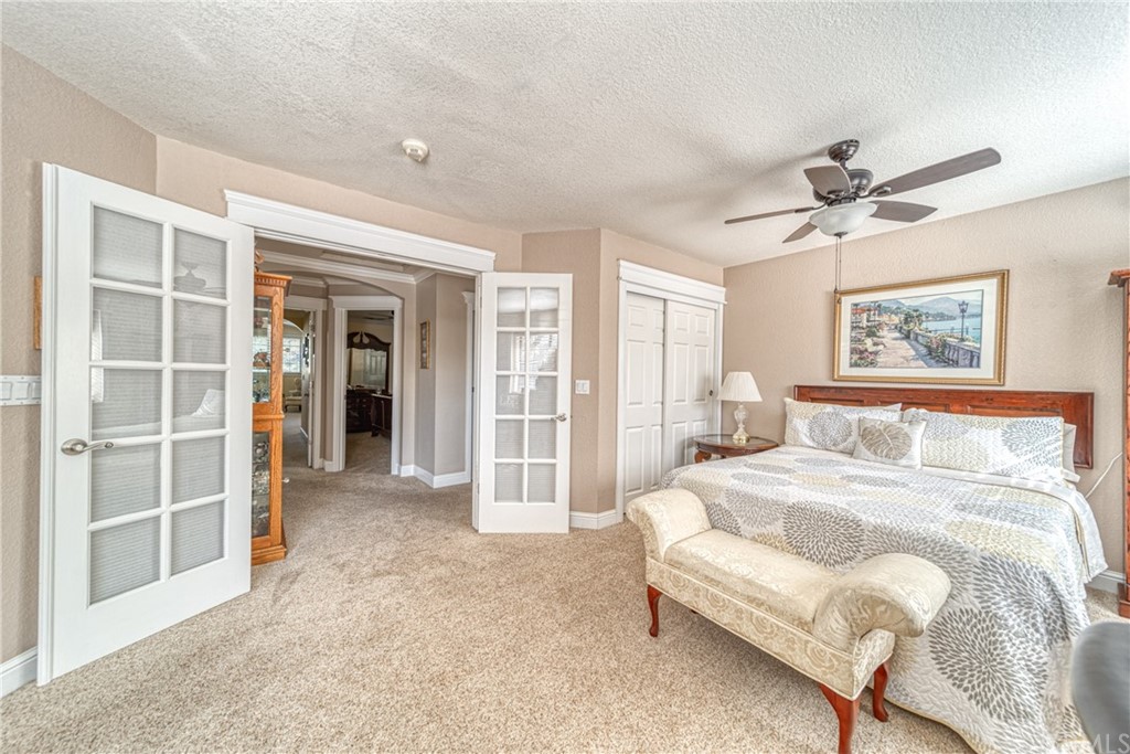 704 Miller Avenue Chico, CA 95928 - Photo 14 of 38 a spacious bedroom with a bed and a chandelier