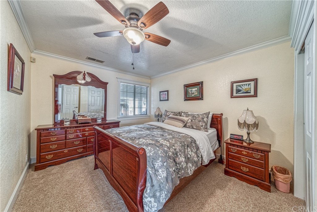 704 Miller Avenue Chico, CA 95928 - Photo 15 of 38 a spacious bedroom with a bed and a chandelier