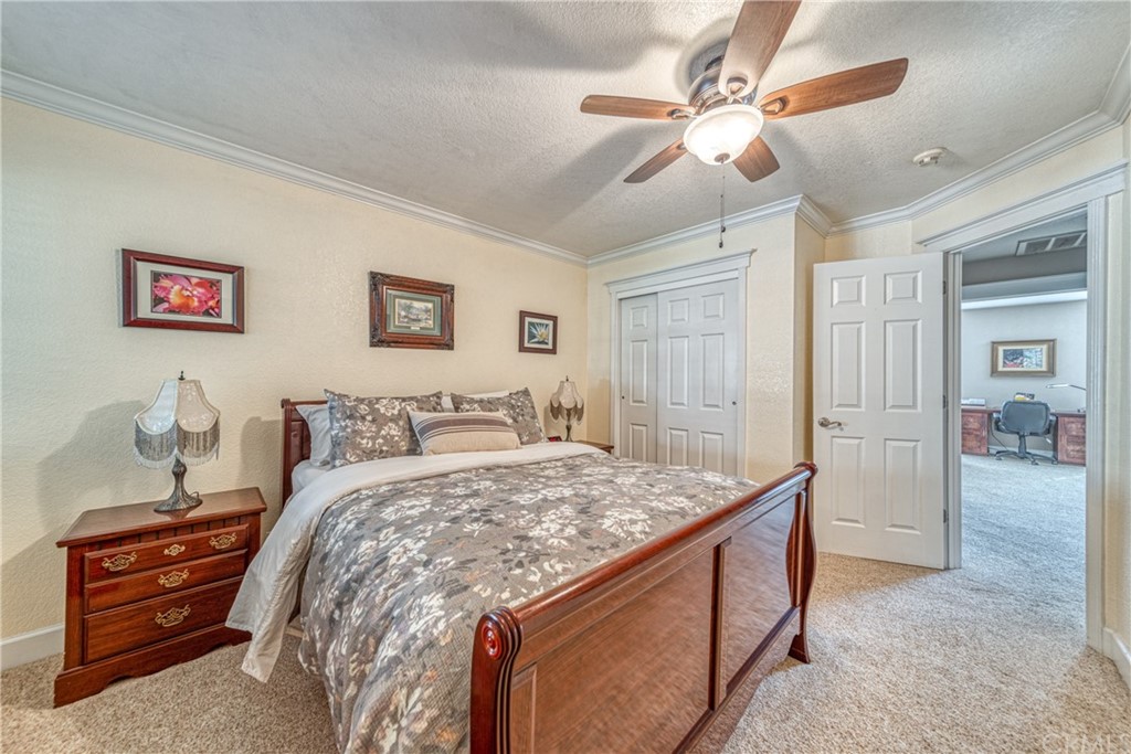 704 Miller Avenue Chico, CA 95928 - Photo 16 of 38 a bed room with a bed and a chandelier