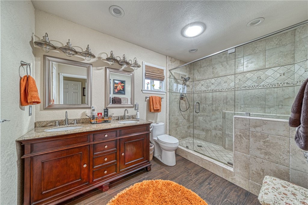 704 Miller Avenue Chico, CA 95928 - Photo 18 of 38 a bath room with a toilet a sink a mirror and a shower