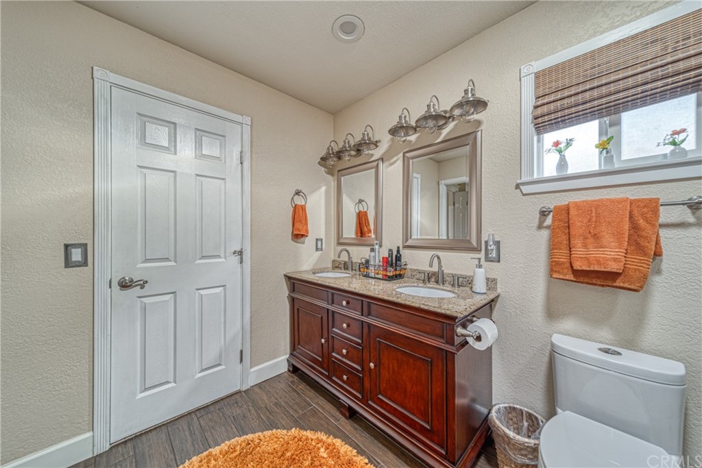 704 Miller Avenue Chico, CA 95928 - Photo 20 of 38 a bathroom with a toilet sink and mirror