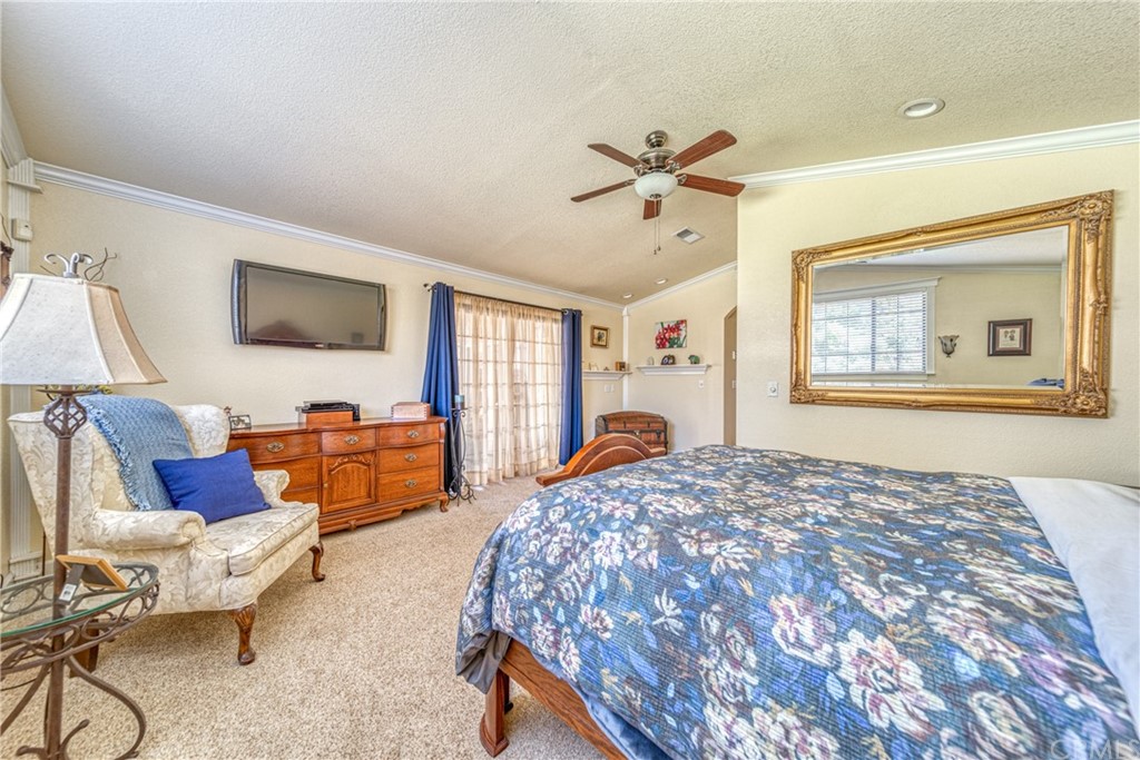 704 Miller Avenue Chico, CA 95928 - Photo 22 of 38 a bedroom with a bed a couch and a flat screen tv