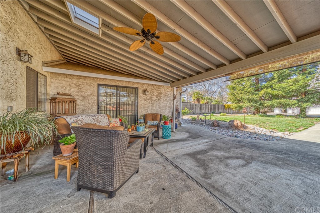 704 Miller Avenue Chico, CA 95928 - Photo 25 of 38 a view of a patio with table and chairs potted plants with wooden floor and fence