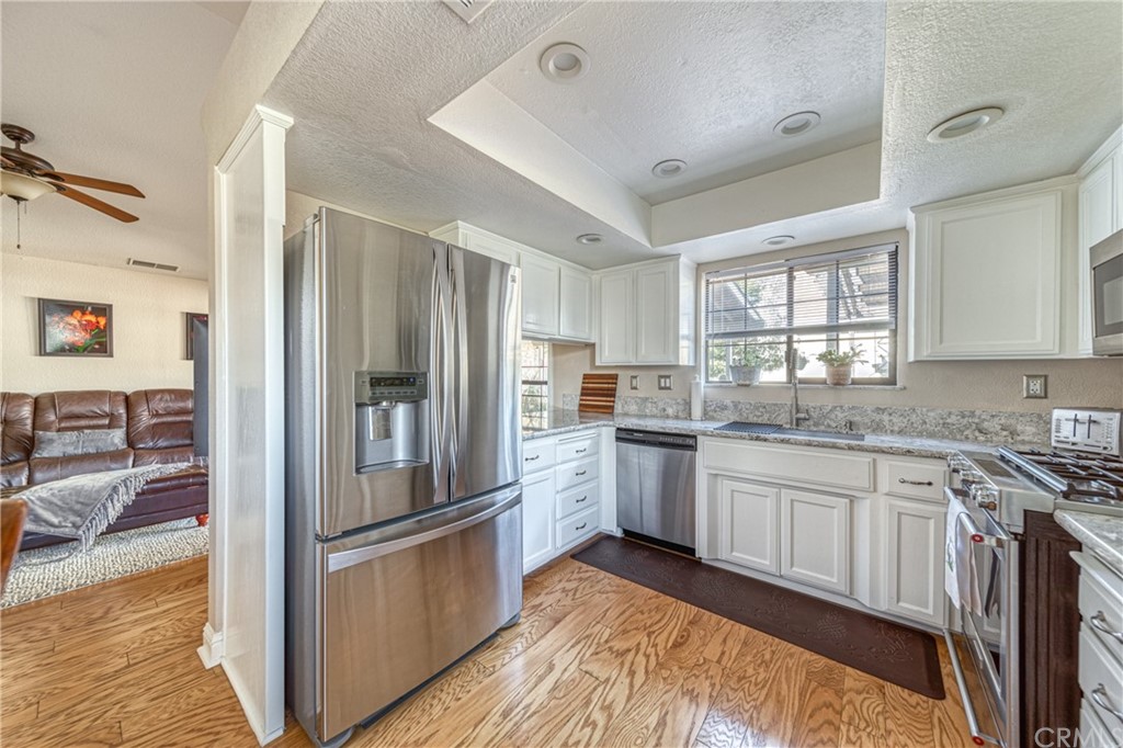 704 Miller Avenue Chico, CA 95928 - Photo 8 of 38 a kitchen with granite countertop stainless steel appliances a sink and counter space