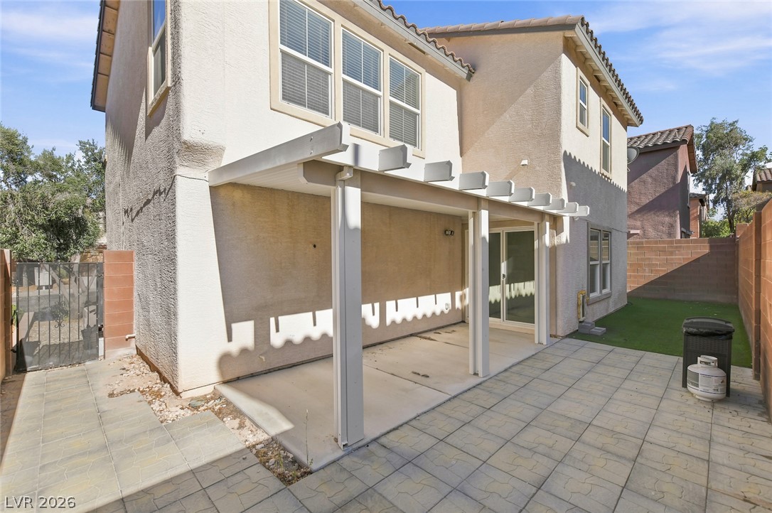 11159 Ranch Valley Street Las Vegas, NV 89179 - Photo 26 of 27 A covered patio extends from the house, offering a tranquil outdoor retreat.