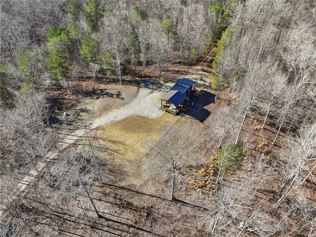 an aerial view of a house with a yard swimming pool and lake view