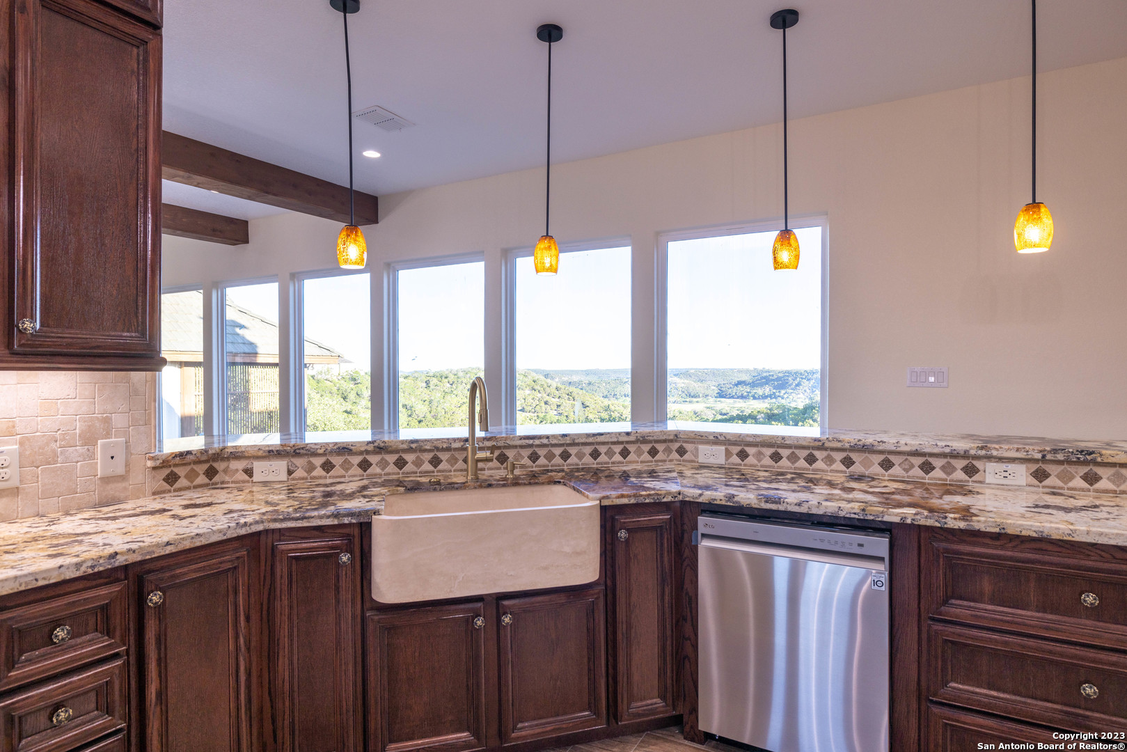 86 Hannah Lane Boerne, TX 78006 - Photo 20 of 45 a kitchen with granite countertop a stove a sink and a wooden floors