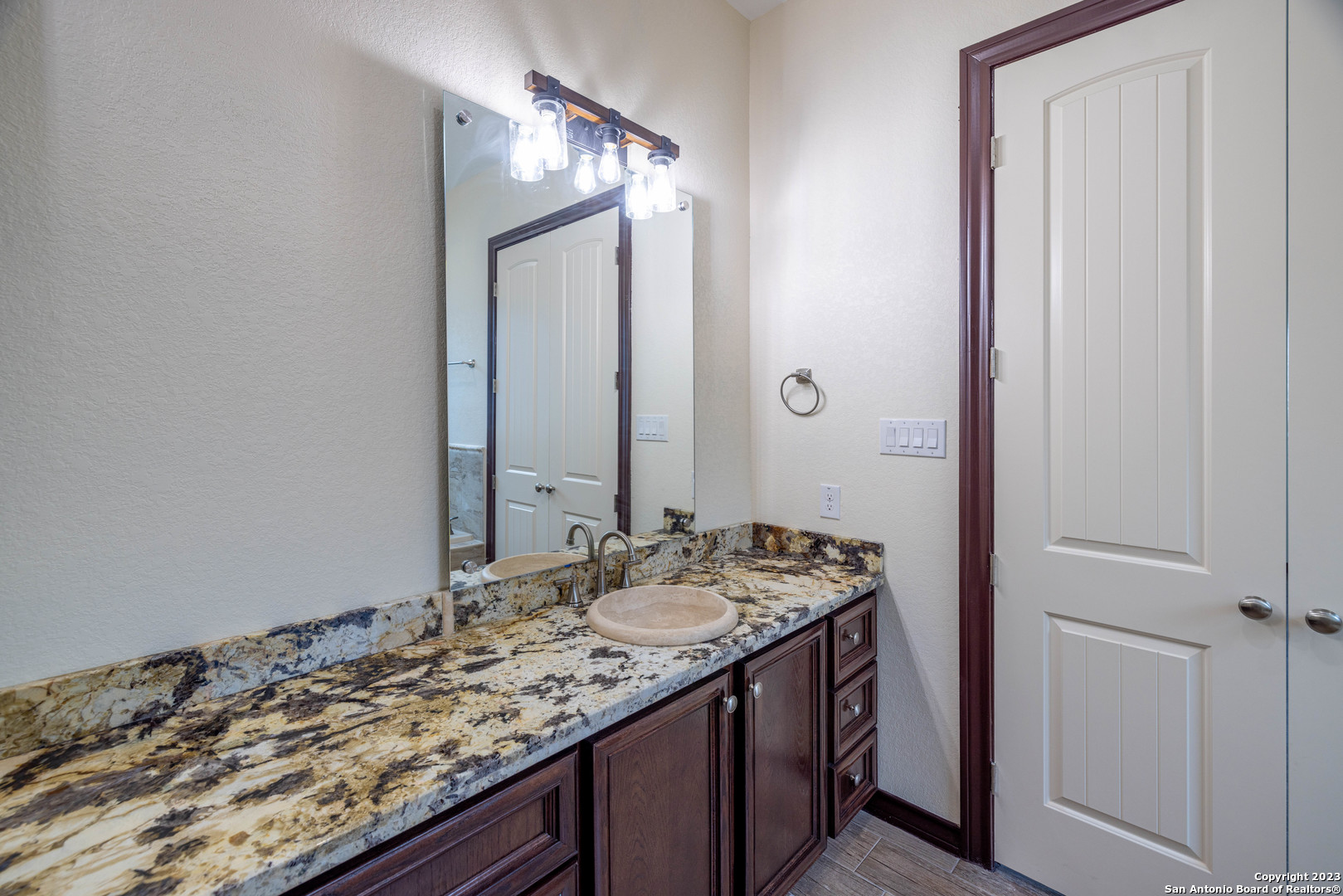86 Hannah Lane Boerne, TX 78006 - Photo 30 of 45 a bathroom with a granite countertop sink and a mirror