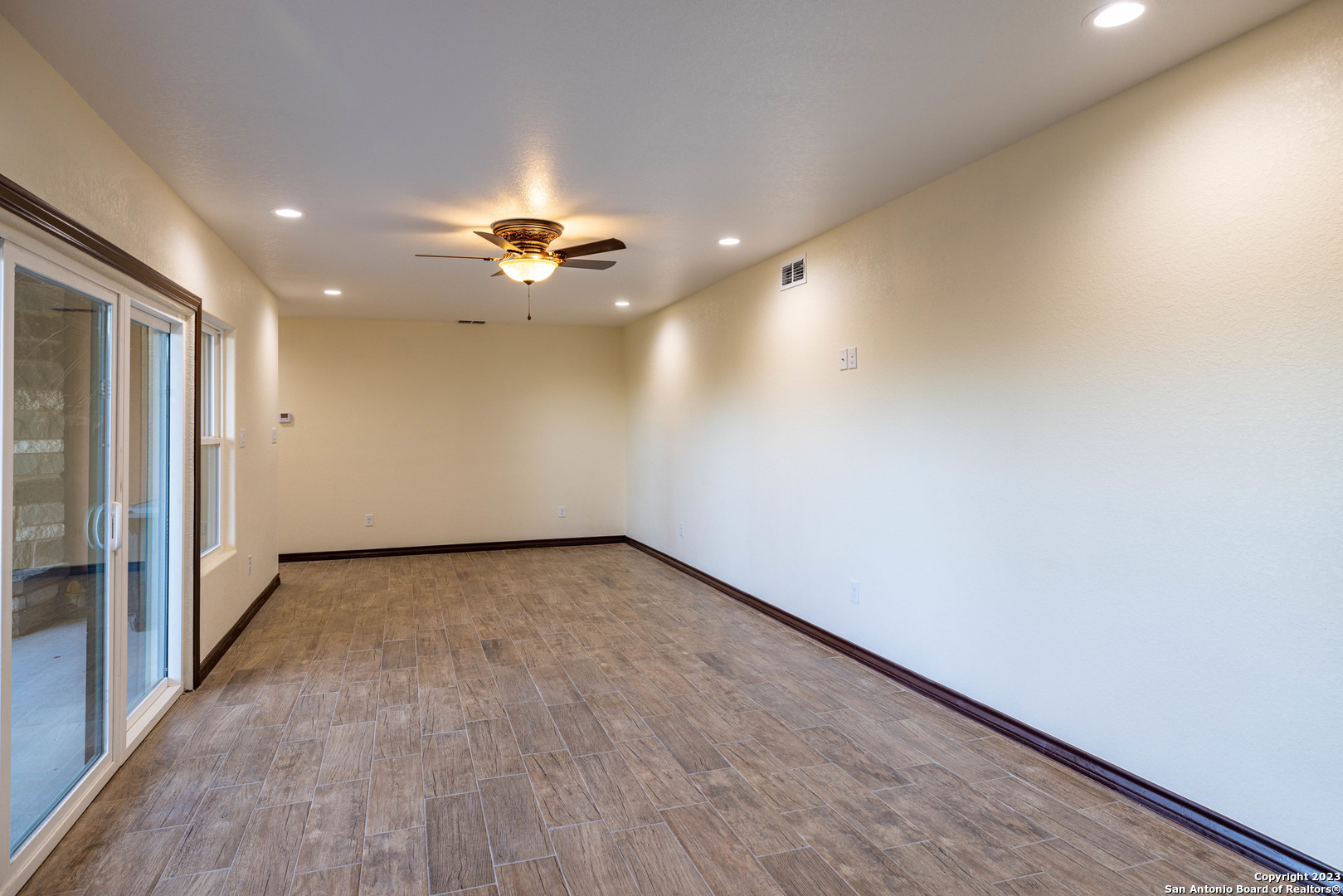 86 Hannah Lane Boerne, TX 78006 - Photo 32 of 45 an empty room with a ceiling fan and carpet