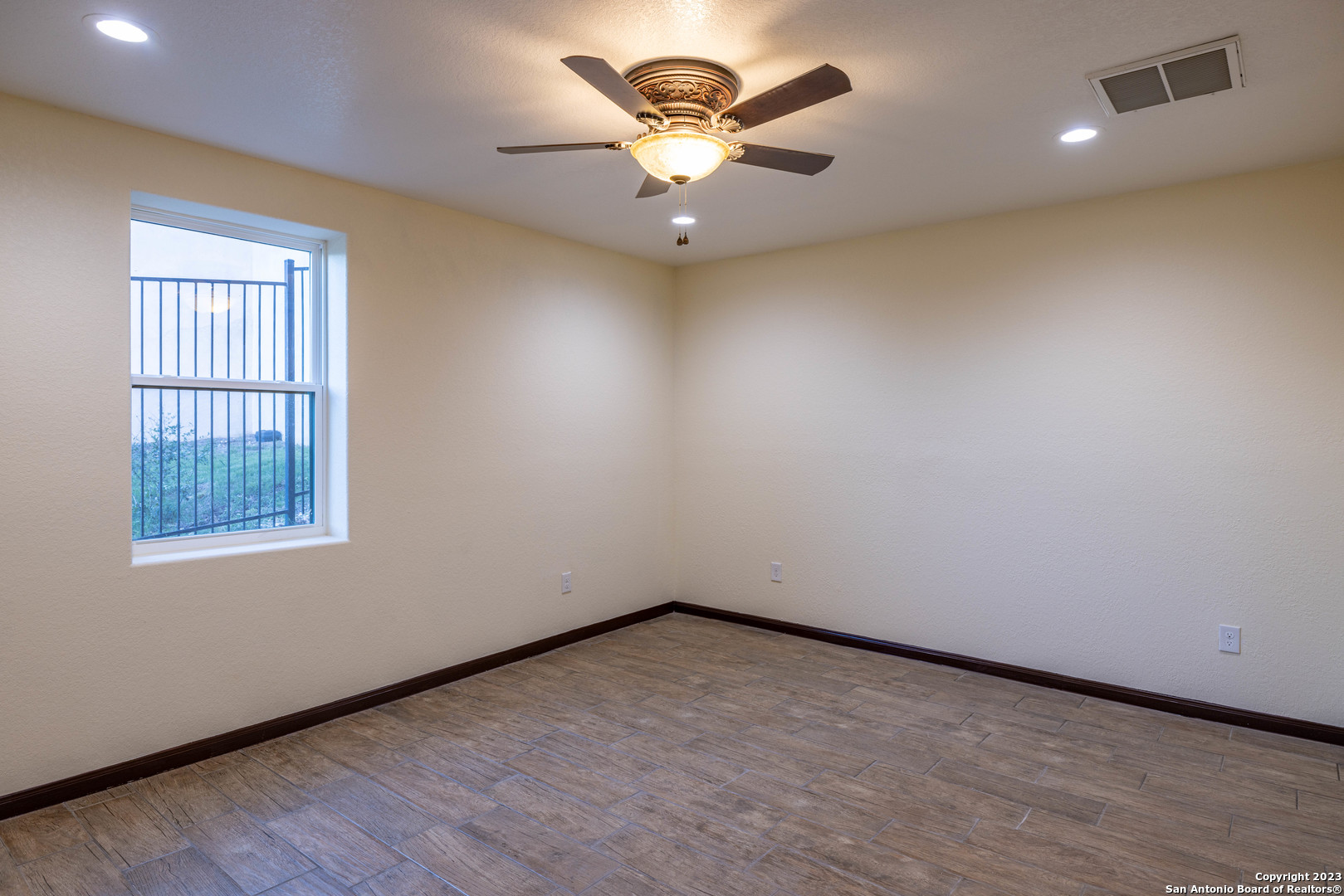 86 Hannah Lane Boerne, TX 78006 - Photo 34 of 45 an empty room with windows and ceiling fan