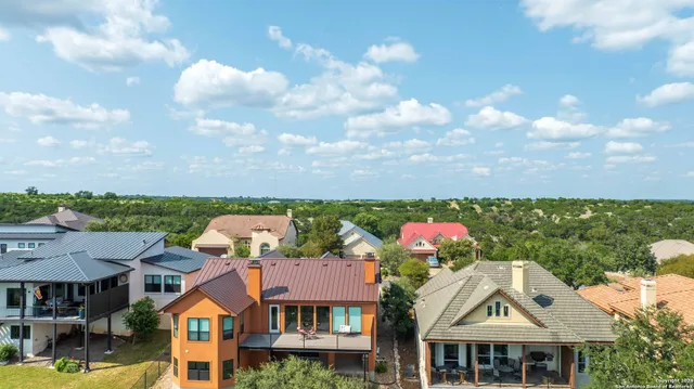 an aerial view of a house with swimming pool and outdoor seating