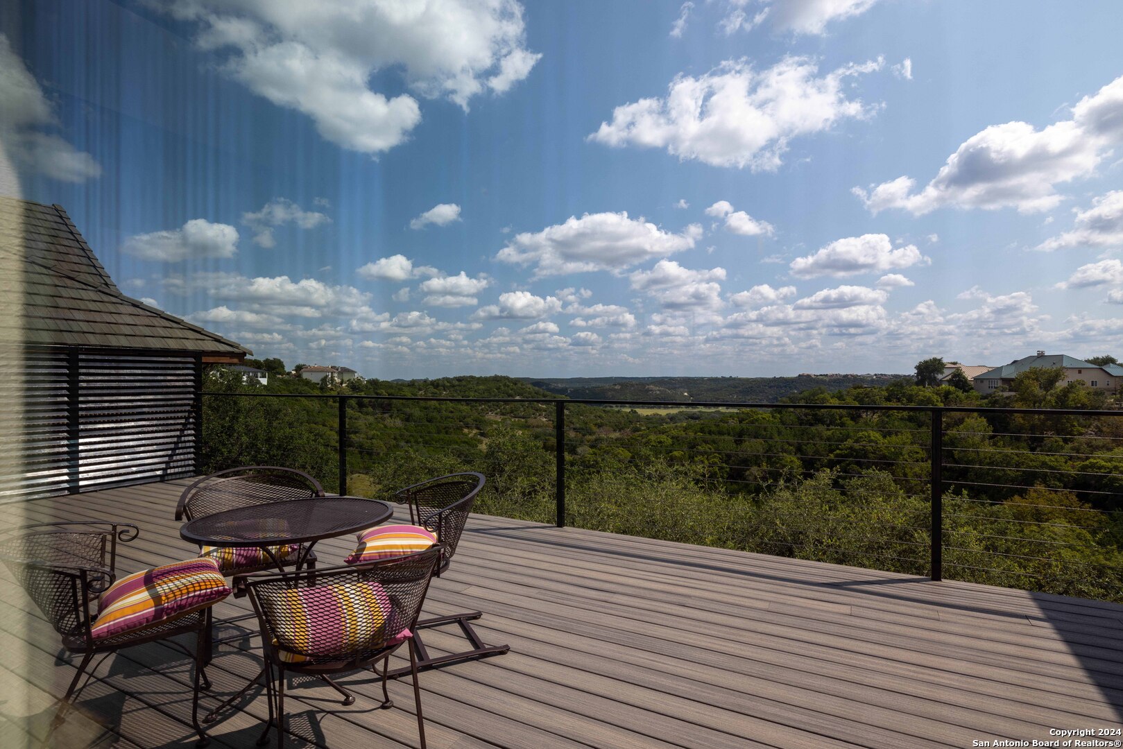 86 Hannah Lane Boerne, TX 78006 - Photo 8 of 45 a view of a roof deck with table and chairs with wooden floor and fence