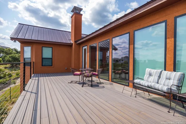 a balcony with furniture and wooden floor
