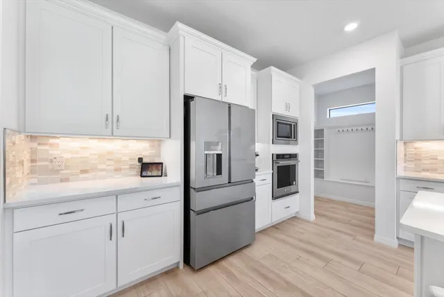 a kitchen with cabinets and steel stainless steel appliances