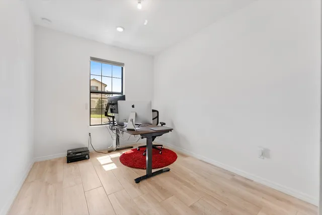 a view of a room with wooden floor and furniture