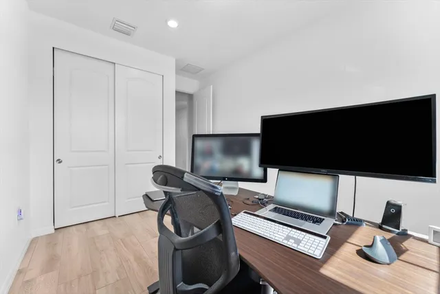 a view of workspace with wooden floor windows