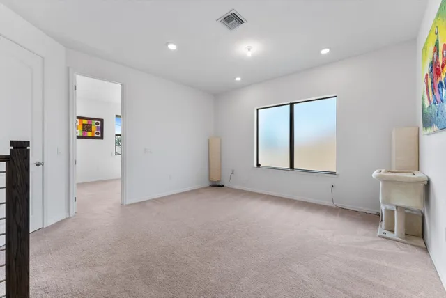 an empty room with windows and closet